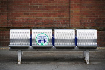 Social distancing sign on seat at train station