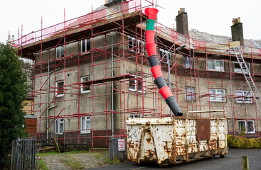 House renovation work with skip and rubbish chute