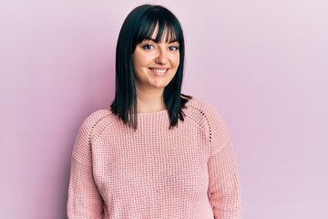 Fototapeta premium Young hispanic woman wearing casual clothes looking positive and happy standing and smiling with a confident smile showing teeth