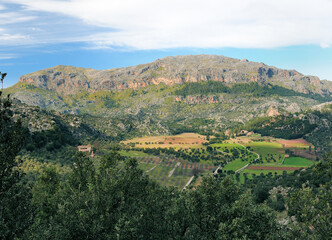 Fototapeta na wymiar View From Lluc To The Fertile Valley Sa Plana On Balearic Island Mallorca On A Sunny Winter Day With A Few Clouds In The Blue Sky