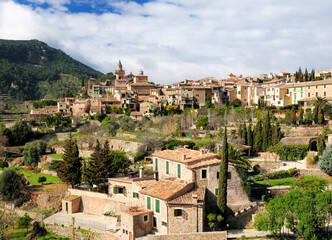 Fototapeta na wymiar View To The Picturesque Historic Village Of Valldemossa On Balearic Island Mallorca On A Sunny Winter Day With A Few Clouds In The Sky