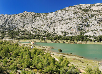 View To Barren Landscape At Lake Cuber In The Tramuntana Mountains On Balearic Island Mallorca On A Sunny Winter Day With A Clear Blue Sky