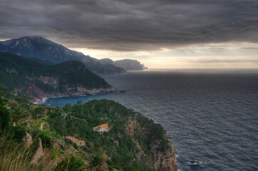 View From The Viewpoint Torre Des Verger To The Mountainous Coastline Of The Tramuntana Mountains On Balearic Island Mallorca On An Overcast Winter Day With Sunshine In The Far Distance