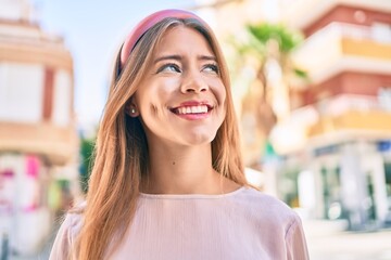Young caucasian girl smiling happy walking at the city.