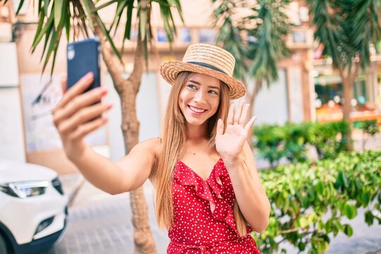 Young caucasian tourist girl smiling happy doing video call using smartphone at the city.