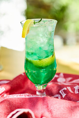 A fruit lemonade on red carved tablecloth