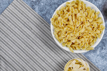 A bunch of uncooked pasta on marble background