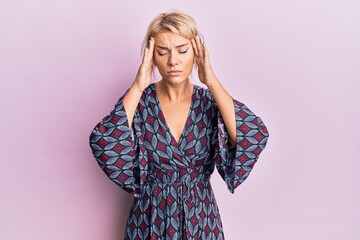 Young blonde girl wearing casual clothes suffering from headache desperate and stressed because pain and migraine. hands on head.