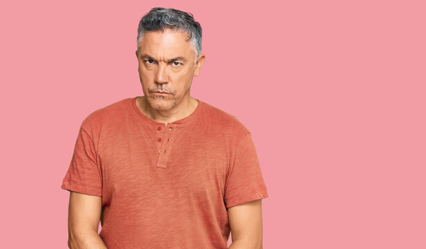 Handsome middle age man wearing casual clothes skeptic and nervous, frowning upset because of problem. negative person.