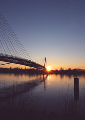 Fototapeta na wymiar Sunset under the Mimram footbridge over the Rhine river at French German bodrer in Strasbourg