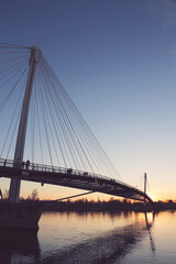Fototapeta na wymiar Sunset under the Mimram footbridge over the Rhine river at French German bodrer in Strasbourg