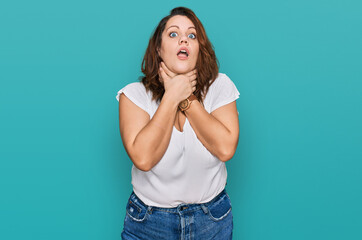 Young plus size woman wearing casual white t shirt shouting suffocate because painful strangle. health problem. asphyxiate and suicide concept.