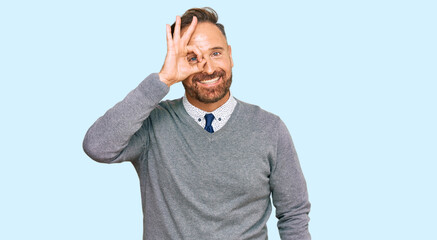 Handsome middle age man wearing business clothes doing ok gesture with hand smiling, eye looking through fingers with happy face.