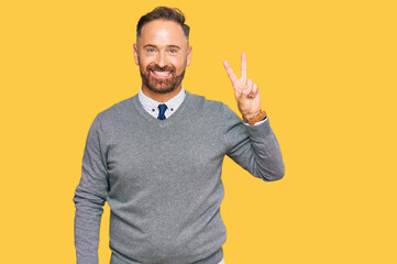 Handsome middle age man wearing business clothes showing and pointing up with fingers number two...