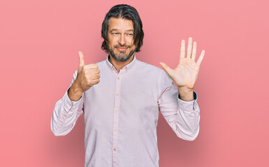 Middle age handsome man wearing business shirt showing and pointing up with fingers number six while smiling confident and happy.