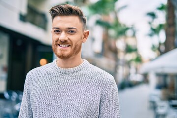 Fototapeta premium Young caucasian man smiling happy standing at the city.