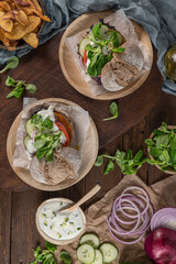 Healthy vegan burger with fresh vegetables and yogurt sauce