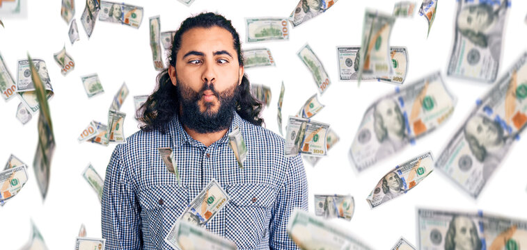 Young arab man wearing casual clothes making fish face with lips, crazy and comical gesture. funny expression.