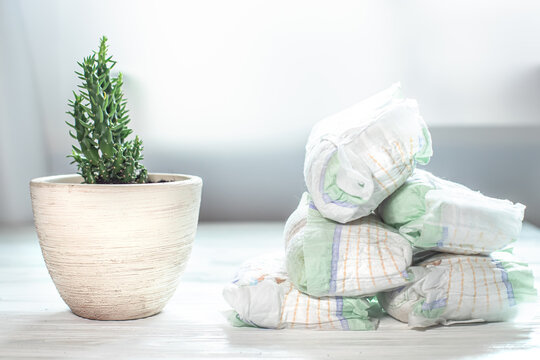Used diapers near flower. Non-environmental use of products. Environmental problems with recycling
