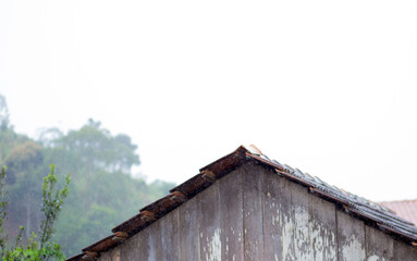 Fototapeta na wymiar Rain on old roof of a house