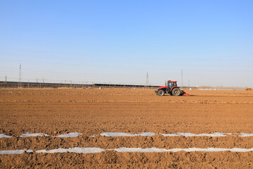 Farmers drive planters to grow potatoes on the farm.
