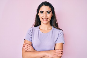 Brunette teenager girl wearing casual clothes happy face smiling with crossed arms looking at the camera. positive person.