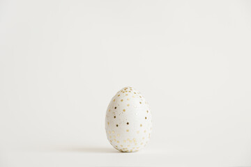 Easter white egg with glitter stars isolated on white background. Minimal easter concept. Happy Easter card with copy space for text. Top view, flatlay. Concept for banner, flyer, invitation, greeting