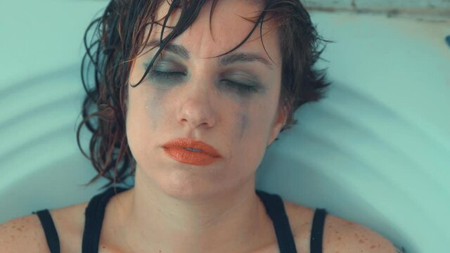 wash away the memories - girl with eyes closed estranged from reality 