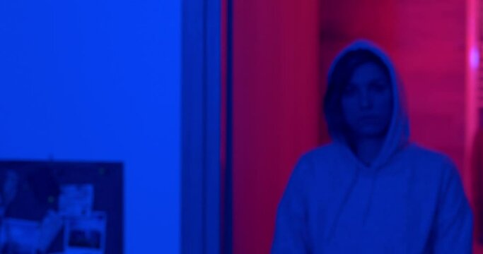 rebellion, challenge - serious hooded girl approaches the camera defiantly
