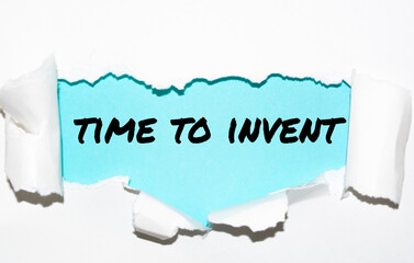 The word time to invent appearing behind torn paper
