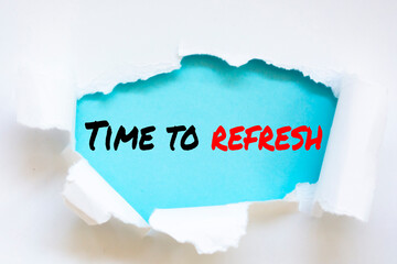 The word time to refresh appearing behind torn paper