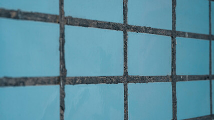 Grunge texture of blue broken tiles on old wall