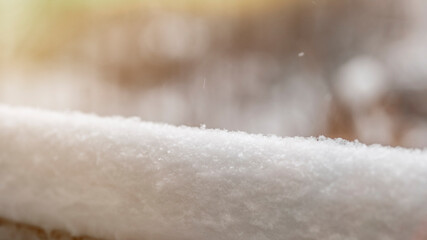 A thick layer of snow on the background of trees. Winter holidays background with snow texture....