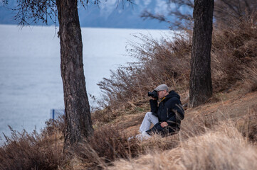 a photographer on the shore of lake baikal photographs nature