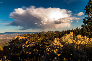 dramatic fleeting huge cumulonimbus clouds with a touch of a rainbow in Bryce Canyon National Park in Utah.