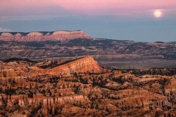 dramatic sunset with the harvest full moon in view in Bryce Canyon National Park in Utah