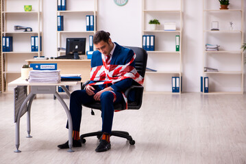 Tied male employee working in the office