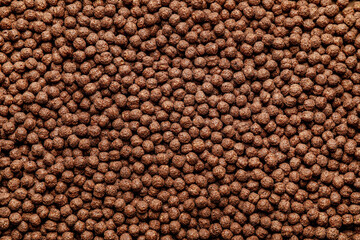 Tasty chocolate corn balls as background, closeup
