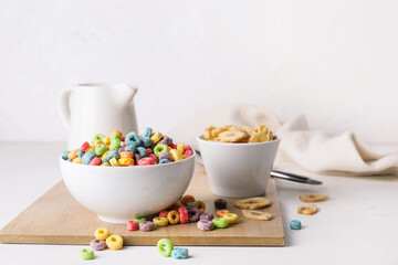 Composition with tasty cereal rings on light background