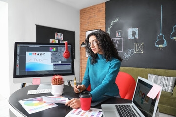 Young female designer working in office