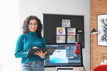 Young female designer working in office