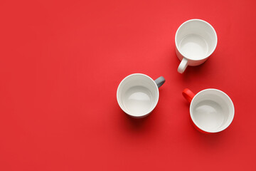 Empty cups on color background