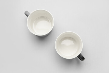Empty cups on light background