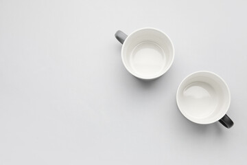 Empty cups on light background