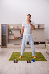 Young man doing sport exercises at home