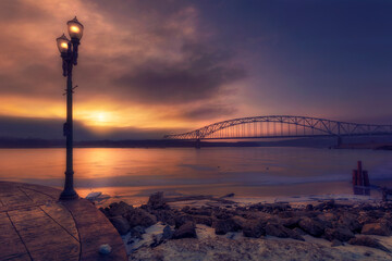 Bridge and street light in Mississippi River during a Sunset