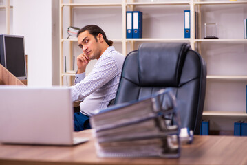 Young male employee working in the office