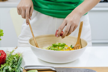 Obraz na płótnie Canvas Eat healthy food for good wellness health concept. Woman cooking salad menu with fresh organic vegetables