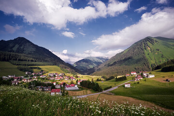 Fototapeta na wymiar Amazing alpine scenery from Berwang, Austria. Summer landscape with green fields and Alps Mountains.