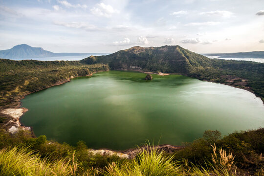 dramatic photos of the worlds smallest volcano. The Taal volcano in the Philippines before its eruption in 2020.The volcano's caldera when the volcano was still dormant.